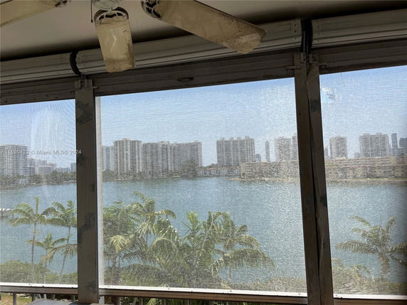 View of water and buildings from behind a screen.