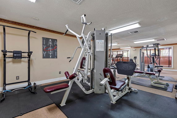 Indoor gym area with exercise equipment and training machines.