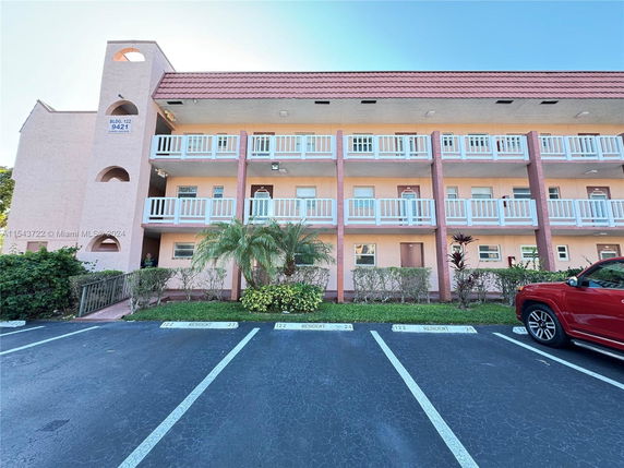 Front view of a multi-story residential building with balconies.
