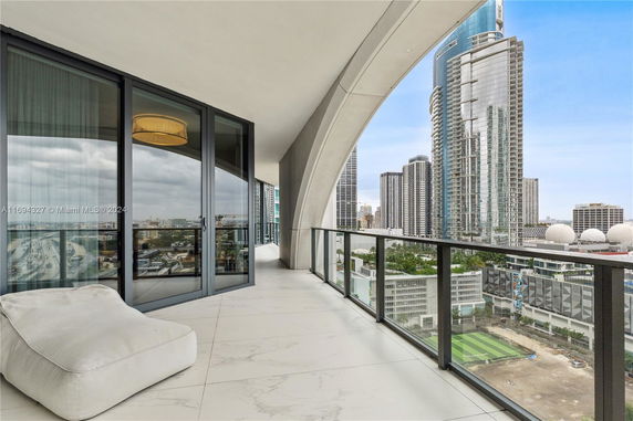 Balcony of a building offering a panoramic view of a cityscape with tall skyscrapers.