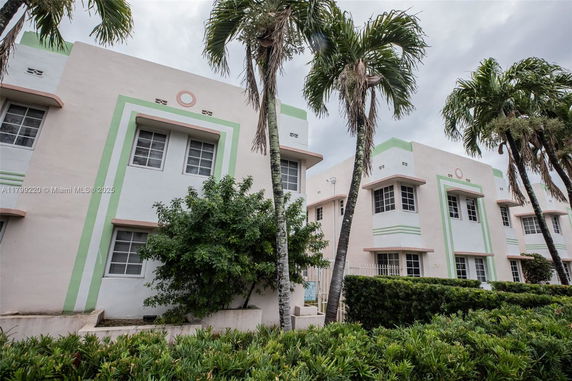 Front view of a multi-story building with art deco design elements and pastel colors.
