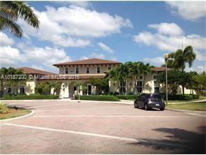 Front view of a large two-story house with a driveway.