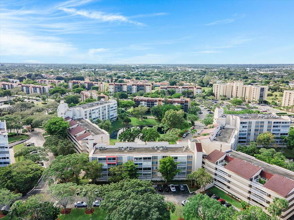 Aerial view of a residential area with multiple apartment buildings and greenery.