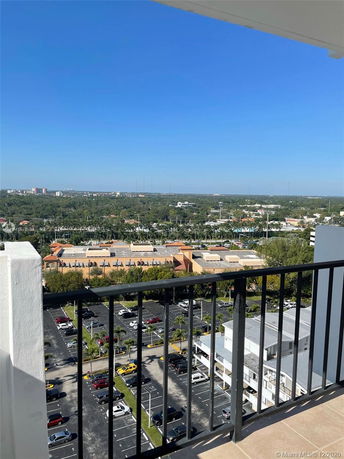 Panoramic view from a high vantage point showing a parking area and surrounding landscape.