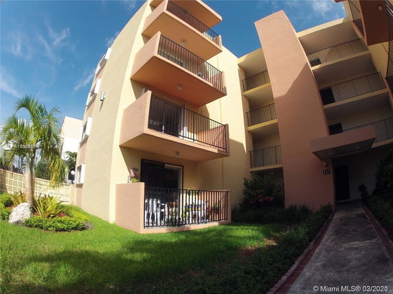 Front view of a multi-story building with balconies.