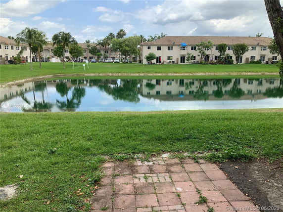 View of a body of water with residential buildings in the background.