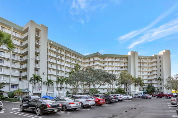 Outdoor parking area in front of a multi-story building