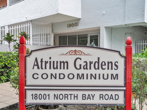 Front view of Atrium Gardens Condominium entrance with signage.