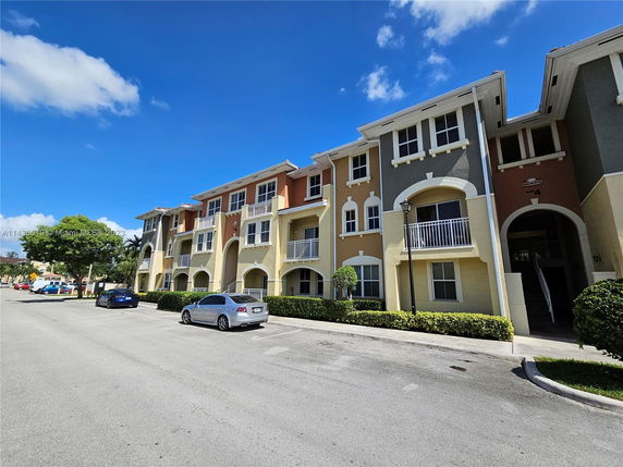 Front view of a multi-story residential building with balconies.