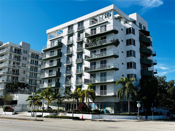 Front view of a multi-story residential building with balconies.