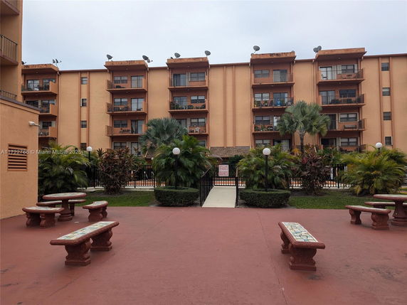 Front view of a multi-story apartment building with balconies.