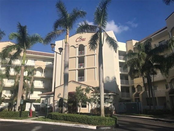 Front view of a multi-story residential building with balconies.