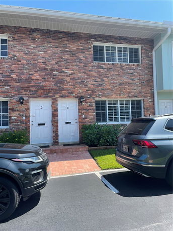 Front view of a two-story brick building with two doors labeled 18 and 19.