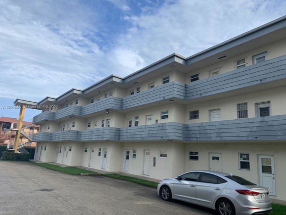 Front view of a three-story building with multiple balconies.