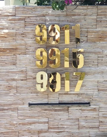 Wall with large gold numbers 9911, 9915, and 9917.