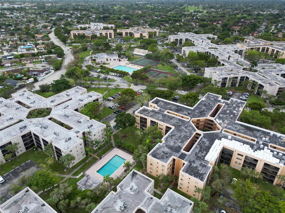 Panoramic aerial view of a residential complex with multiple apartment buildings and surrounding greenery.