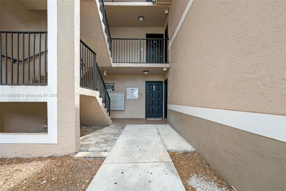 Exterior view showing stairs and entrance to a multi-story building.