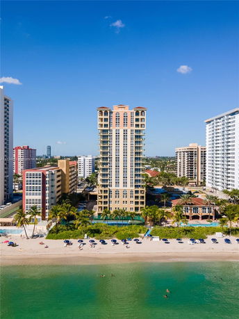 Front view of a multi-story building near a beach.