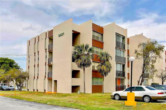 Front view of a multi-story apartment building with balconies.