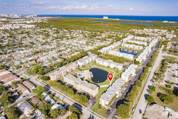 Aerial view of a residential neighborhood with multiple buildings and surrounding areas.