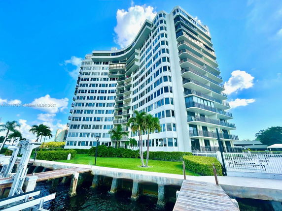 Front view of a high-rise residential building with multiple balconies.
