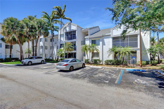 Front view of a multi-story residential building with balconies.