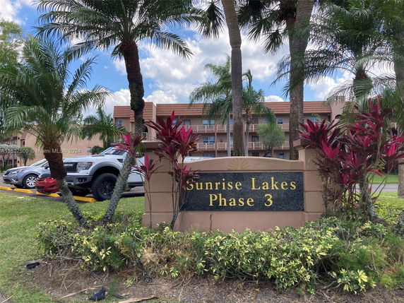 Front view of a multi-story building at Sunrise Lakes Phase 3.