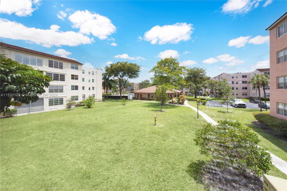 View of a residential area with multiple apartment buildings and open green spaces.