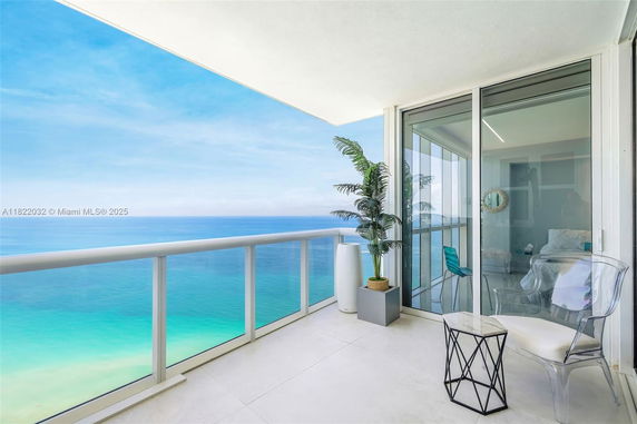 Balcony with a view of the ocean and glass railing.
