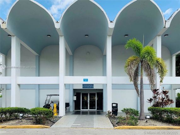 Front view of a building with an arched roof and glass entrance doors.