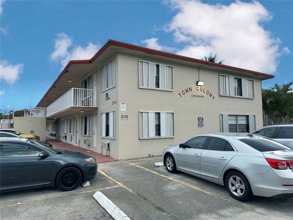 Front view of a two-story condominium building labeled 'Town Colony.'