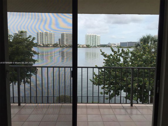 View of buildings and waterfront from a balcony.