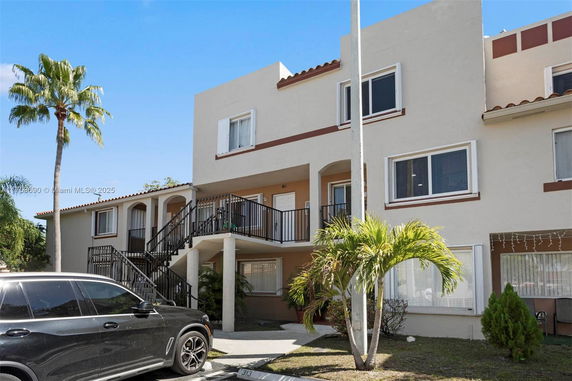 Front view of a multi-story building with external staircases.