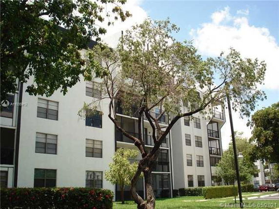 Front view of a multi-story apartment building with balconies.