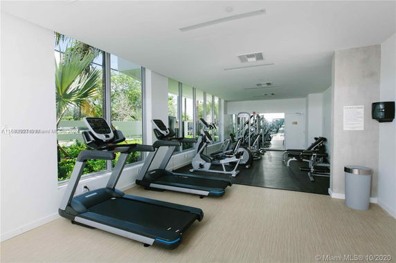 Interior view of a gym with treadmills and other exercise equipment.