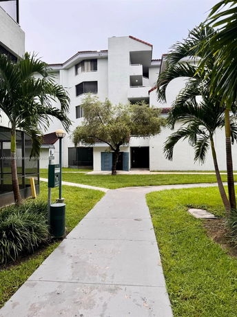 Front view of a multi-story residential building with balconies.
