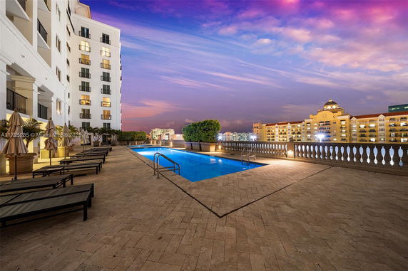 Outdoor swimming pool on a terrace with city views.