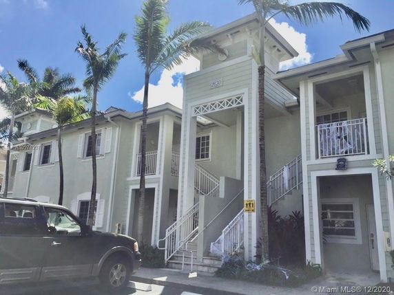 Front view of a two-story building with multiple staircases and balconies.