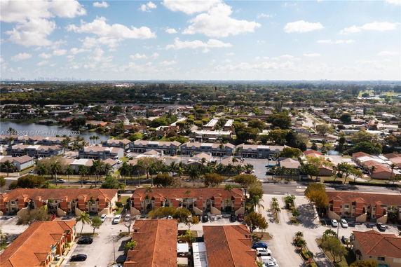 Wide angle view of residential area with rows of houses and roads.