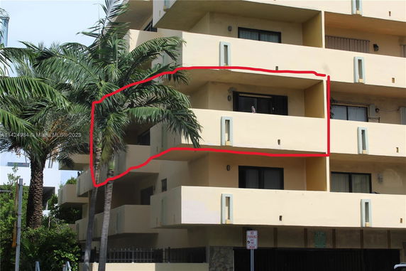 Front view of a multi-story building with balconies.