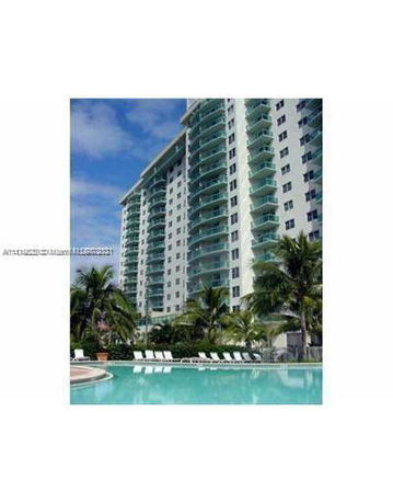 Front view of a multi-story residential building with balconies.