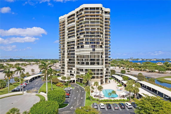 Front view of a tall, modern condominium building with multiple balconies.