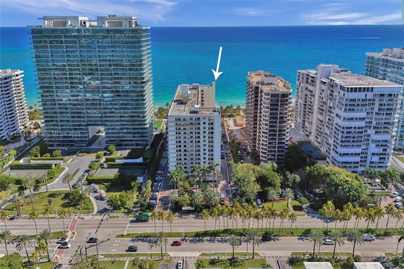 Aerial view of multiple high-rise buildings near the coastline with the ocean in the background.