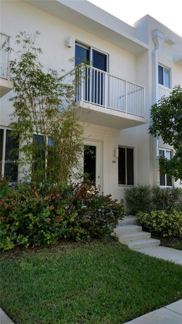 Front view of a two-story house with a small balcony.