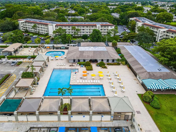 Outdoor view of a swimming pool area with surrounding amenities.