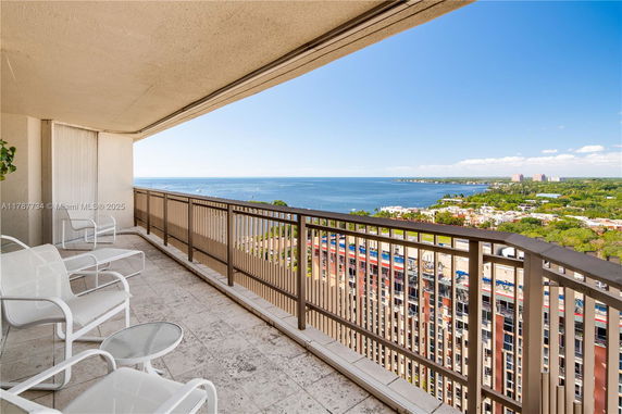 Panoramic view from a balcony overlooking a body of water and cityscape.