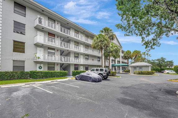 Front view of a multi-story residential building with balconies.
