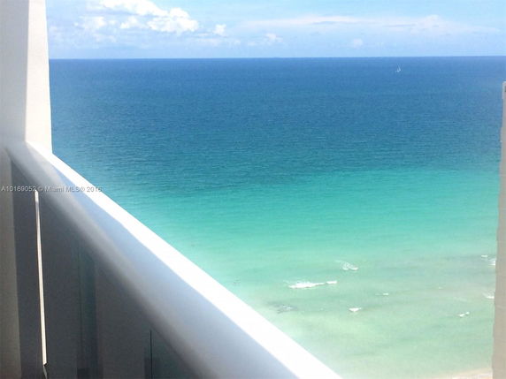 Panoramic view of the ocean from a building balcony.