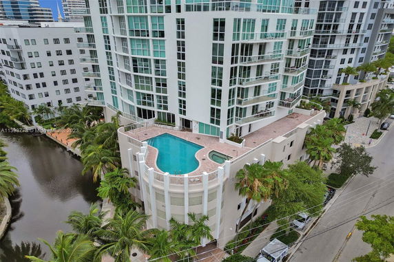 Outdoor swimming pool on the upper level of a modern multi-story building.