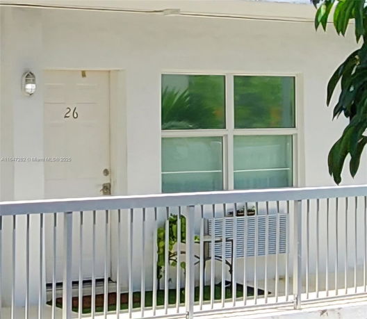 Front view of a building entrance with a door and window.